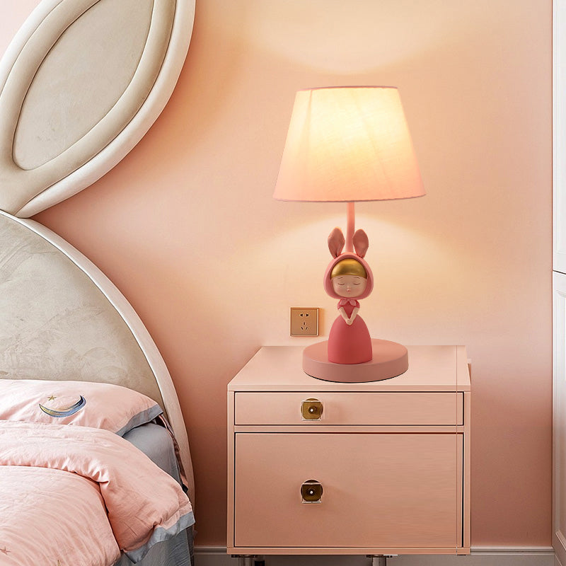 Kids' Pink Fabric Drum Table Lamp with Resin Figurine - Tapered Design for Bedroom Nightstand