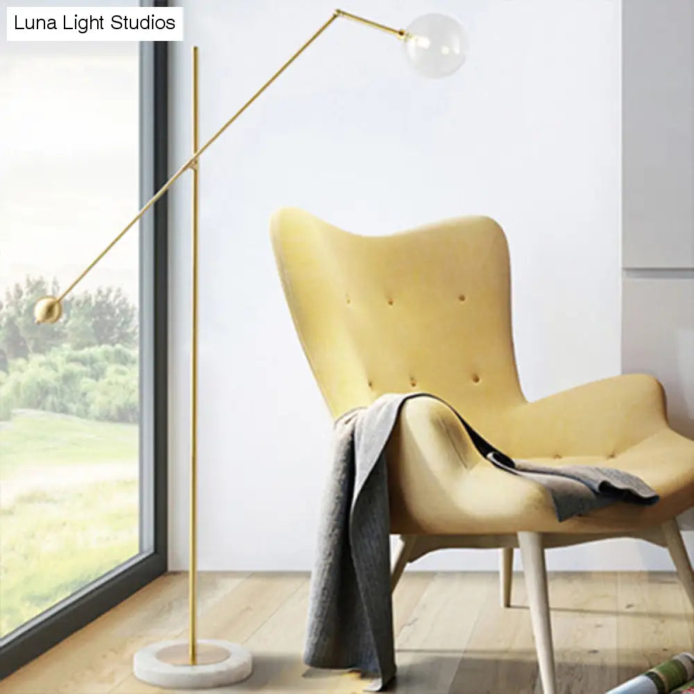 Modernist Gold Metal Balance Arm Task Floor Lamp with Orb Design – Single Bulb Standing Light for Office
