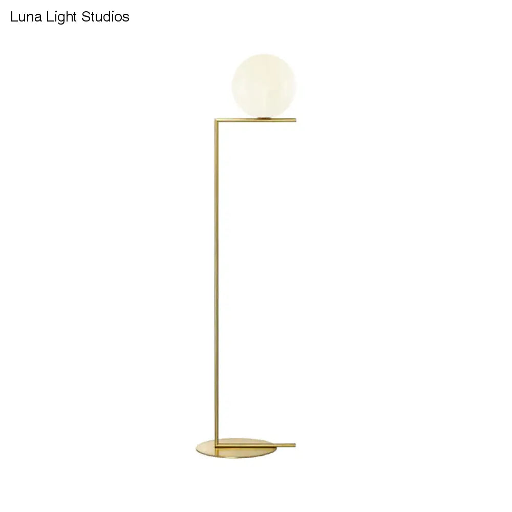Minimalist Gold Orb Floor Lamp with Frosted Glass Shade and Right Angle Stand