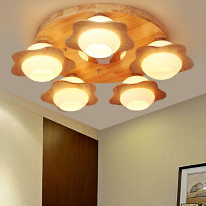 Wood-toned ceiling fixture with five ivory flower-shaped glass shades
